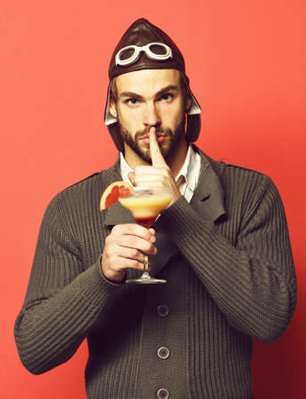 bearded pilot with cocktail in glassの写真素材