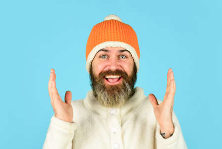 I cant believe in it. knitwear hat protect from cold. bearded man wear winter hat. fashion clothes for cold weather. mature hipster blue background. male fashion style. autumn weather forecastの写真素材