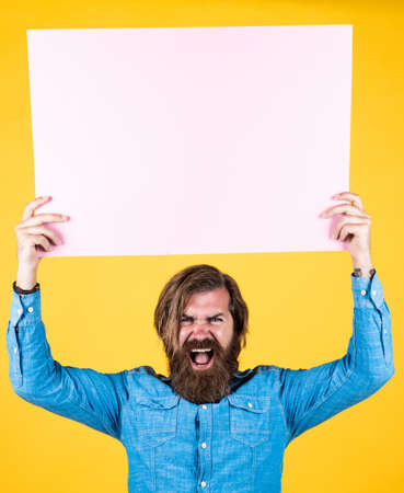 meeting for voting. need help. bearded man holding placate. wanted. empty paper for your information. barber concept. happy hipster with beard at paper sheet. empty place for copy spaceの写真素材