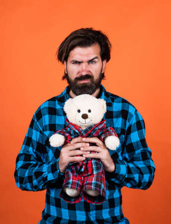 serious bearded male hipster hold teddy bear toy, Childish Habitsの写真素材