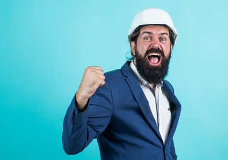 mature engineer man in suit and helmet shouting and feel happiness about successful business deal,...