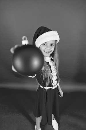 Happy child red costume hold christmas ornaments close up selective focus. Shop for decorations. Take it. Create unique decorations. Christmas ball decor. Christmas decorating ideas for kids roomの写真素材