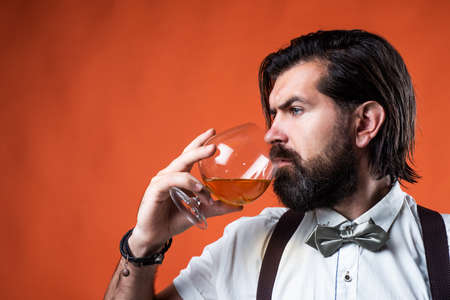 mature man barman drinking hard alcohol beverage from glass, bachelorの写真素材