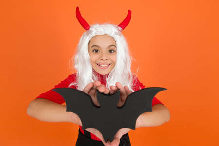 happy halloween. trick or treat concept. carnival festive costume of witch. kid with bat in white...