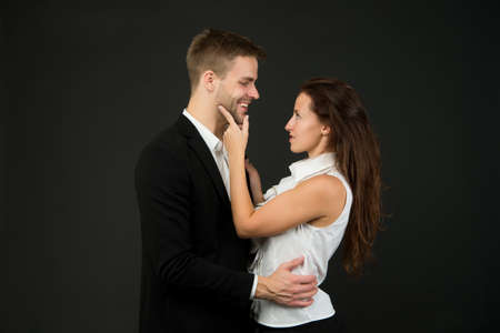 young couple in love of man in suit and woman in shirt is hugging each other, romantic and business...