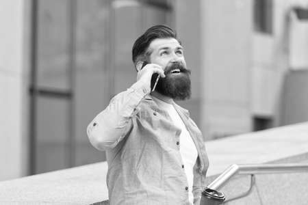 Do you hear me. Bearded man use smartphone outdoors. Mobile technology. New technology. Cellular technology. Modern life. Technology for communicationの写真素材