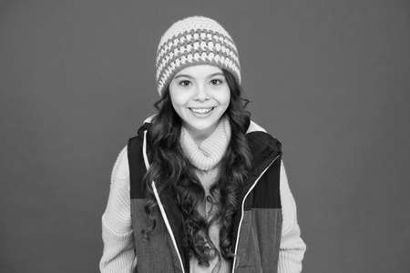 Update your look in winter. Happy child with beauty look red background. Vogue look of small fashion...