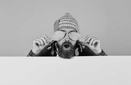 Man in warm hat closes eyes with cherry leavesの写真素材