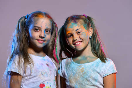 Girls with smiling faces stand on purple backgroundの写真素材