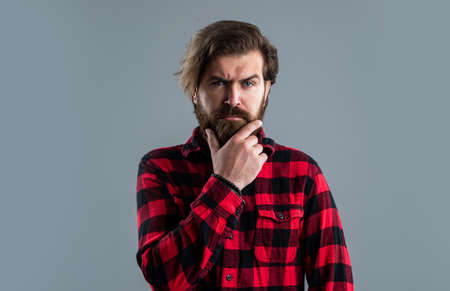 Handsome macho. brutal caucasian hipster with moustache. Male barber care. serious bearded man. Hair and beard care. Confident and handsome brutal man. Facial care. Mature hipster with beardの写真素材