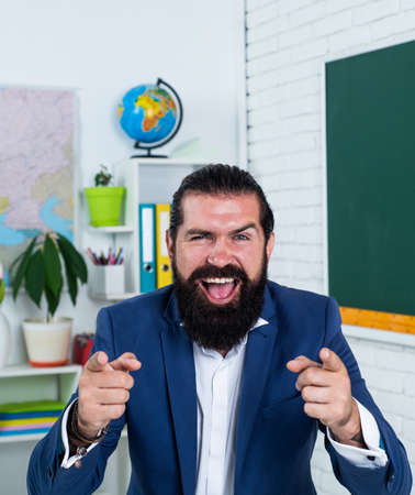 happy and successful teacher man in classroom, school educationの写真素材