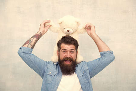 Handsome hipster hold lovely bear toy. Valentines day. Present for your partner. Man with beard...
