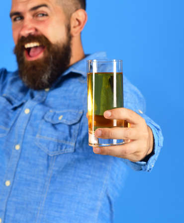 Farmer with happy face holds fresh apple juice, close up.