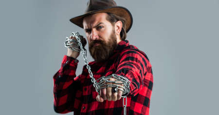 You matter. handsome man with beard hold chain. concept of freedom. man chained problems. liberation from slavery. perfect male charisma. caucasian man with powerful metal chain in handsの写真素材