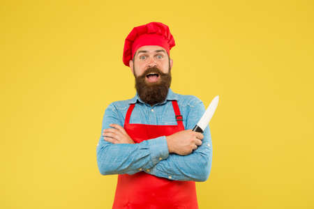 Restaurant food. Hipster handsome cook hold sharp professional knifeの写真素材