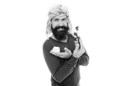 Professional cosmetics. Stylist career. Applying makeup face tone. Powder cosmetics. Man bearded...