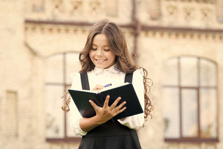 Intellectual task. Cognitive process. Start new school project. Welcome back to school. School girl formal uniform hold book. Towards knowledge. Students life. School student. Intelligent childの写真素材