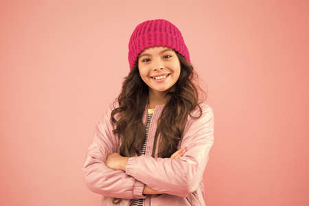 Dress warm in winter. Ready for cold winter. Accessories shop. Carefree and happy. Little kid wear puffer jacket and knitted hat. Winter shopping. Happy childhood. Trendy accessory. Tender styleの写真素材