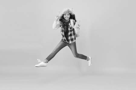 Keep moving. Winter season concept. Kid girl wear hat with ear flaps. Winter events at school. Winter entertainment and activities. Child active schoolgirl soft hat enjoy season. Winter vacationsの写真素材