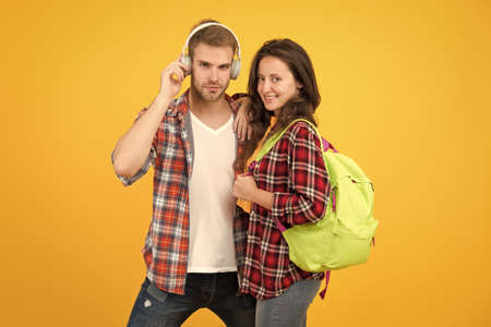 hipster couple ready for learning. ebook and audio book concept. study together is fun. back to...