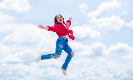 free your imagination. kid beauty and fashion. child jump in casual style. Child jumping on background of sky. summer holiday concept. childhood happiness. happy childrens dayの写真素材