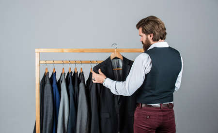 Man buy clothes fashion store menswear suit tuxedo, luxurious wardrobe conceptの写真素材