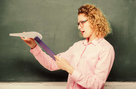Towards knowledge. new school year. Girl prepare for exams. girl teacher at school lesson. report project. back to school. teacher with document folder. concentrated student in glasses at blackboardの写真素材