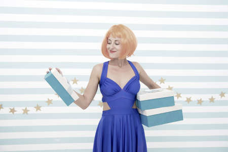 Crazy girl with present boxes. boxing day concept. Pretty girl crazy about present choosing. any gift for every holiday. Every box brings new choice. The choice is yoursの写真素材