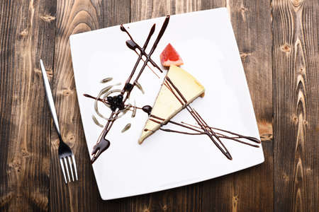 Dessert with chocolate lines, blueberries and grapefruit triangle decorの写真素材