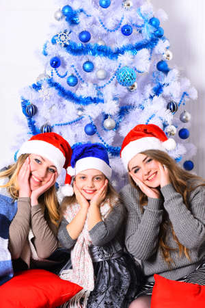 Family or friends in Santa hats near present boxes.の写真素材