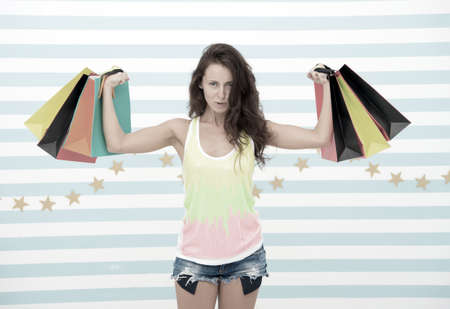 shopping girl with heavy bags. after day shopping. muscular girl hold purchase or present packages. strong shopaholic hold heavy bags. sale benefit. i want this. i need some retail therapy.の写真素材