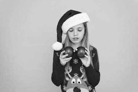 Let kid decorate christmas tree. Favorite part decorating. Add more decorations. Getting child involved decorating. Decorating christmas tree. Girl smiling face hold balls ornaments blue backgroundの写真素材