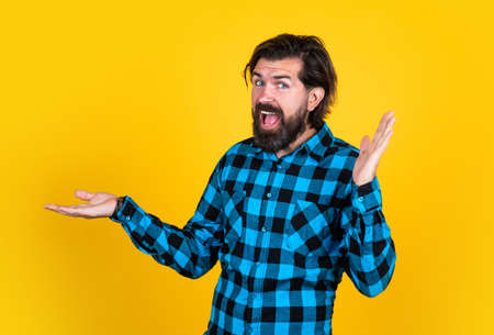 happy brutal guy on yellow background celebrating success, happinessの写真素材