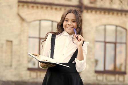Cognitive process. Start new school project. Towards knowledge. Students life. School student. Intelligent child. Welcome back to school. School girl formal uniform hold book. Intellectual taskの写真素材