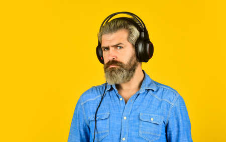 Rhythm concept. Noise cancellation function. Professional gadget. Music beat. Man bearded hipster headphones listening music. Hipster enjoy excellent sound song in earphones. Excellent music playlistの写真素材
