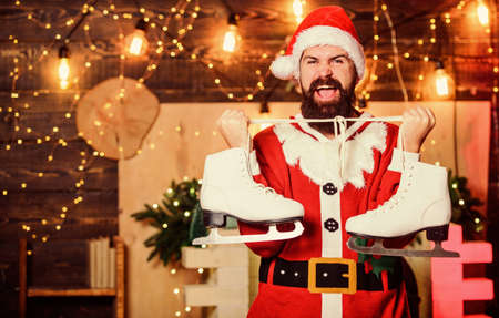 Its for me. santa figure skating. winter sport activity. winter holidays. wait for xmas presents. merry christmas. man santa hat. happy bearded man skates. new year gifts. christmas decorationの写真素材