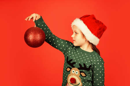 Festive decor. ready for xmas party. happy winter holidays. greeting and congratulation. small santa helper. cheerful kid hold new year present. gift decor and parcel delivery. merry christmasの写真素材