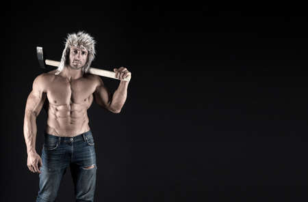 Wellness industry. Strong man hold hammer black background. Heavy factory worker with abs. Wellness...