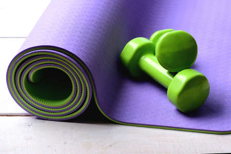 Workout and sport concept. Dumbbells made of green plasticの写真素材