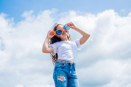 kid fashion and beauty. sense of freedom. portrait of pretty child girl in party glasses. concept of...