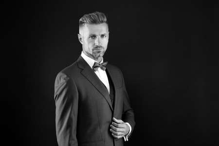 your signature look.   adult man in stylish tuxedo. male fashion and beauty. handsome man has graying unshaven face. skilled sommelier. bride groom on wedding day. event host wear bow tieの写真素材