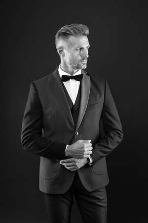 elegant man in formal outfit. handsome event manager. tuxedo man on black background. perfect male. fashion and beauty. aesthetic development concept. ready for special dateの写真素材