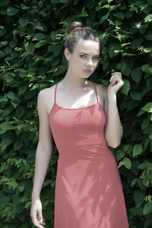 Sensual woman in prague, czech republic on sunny day. Woman with natural makeup on green fence. Girl...