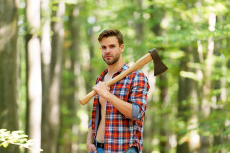 usual work. man ready for splitting wood and cutting firewood with axe. prepare to chop down tree. chopping and splitting firewood with axe. lumber worker in wood. spend picnic weekend in forestの写真素材