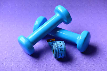 Shaping and fitness equipment. Dumbbells and measure tapeの写真素材