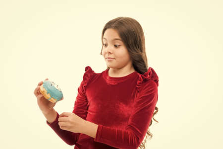 Sweet life. Glazed funny dessert. Yummy food. Sweets shop and bakery concept. Delicious sweet donut. Girl hold donut white background. Kid hungry girl eat donut. Health and nutrition conceptの写真素材
