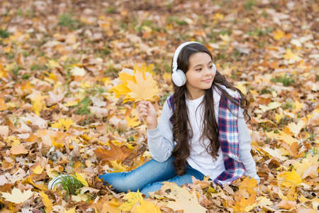 Lost in thoughts. fall maple leaves in park. online education. childhood happiness. beauty and...