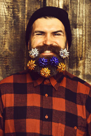 Bearded man, brutal caucasian amused hipster with gift decoration starsの写真素材