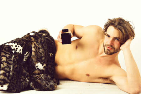 Bearded macho man under fur coat on white background