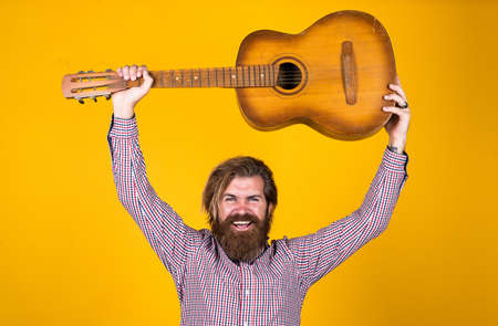 mature hipster musician with beard. brutal caucasian guy playing guitar. country music. bearded man singing song. handsome man singer and guitarist. acoustic guitar playerの写真素材